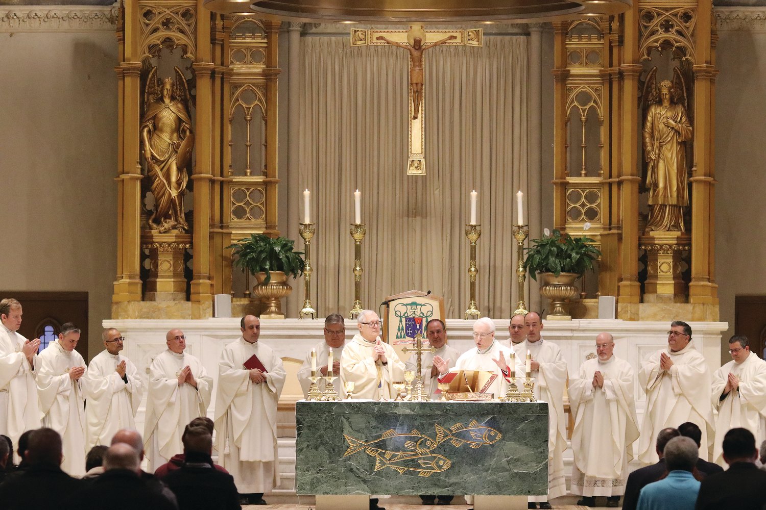 Priests join Bishop Thomas J. Tobin and Auxiliary Bishop Robert C. Evans in celebrating Mass marking the 150th Anniversary of the founding of the Diocese of Providence at the Cathedral of SS. Peter and Paul on Feb. 16.
